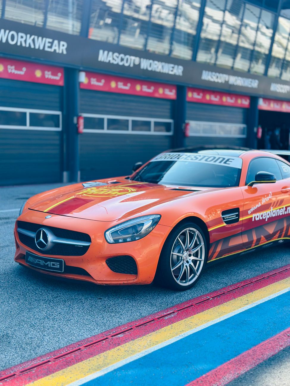 orange mercedes benz sports car at race track
